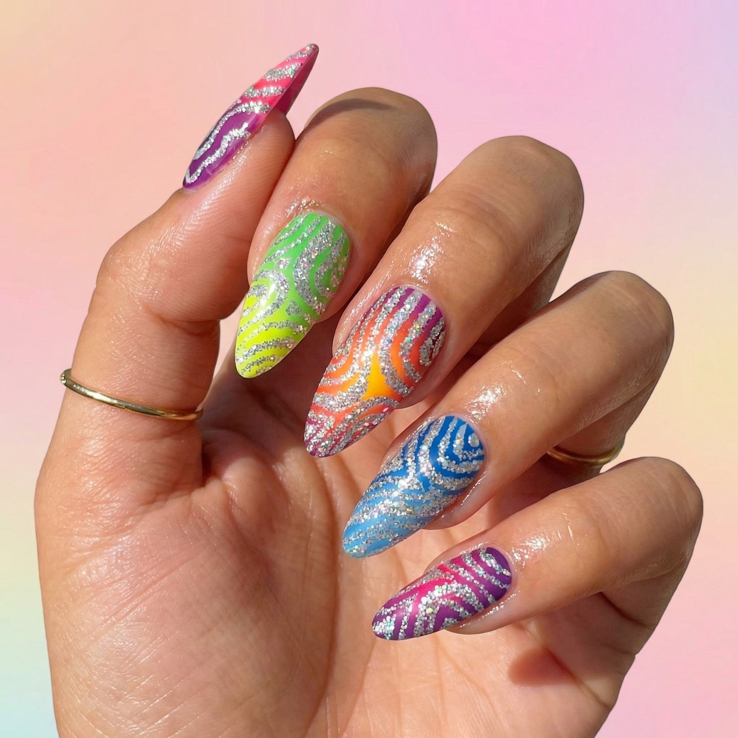 Auntie Cookies Nails Zebra Pop Parade press-on nails with rainbow gradient, silver glitter, and zebra print patterns.