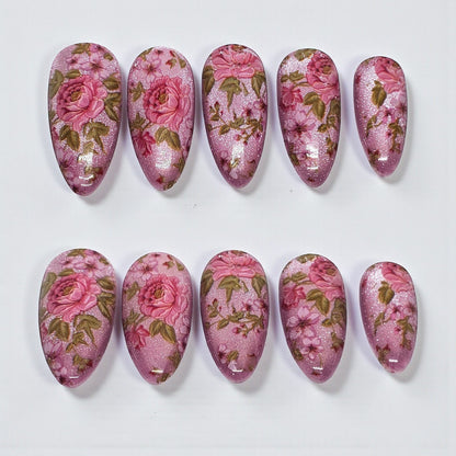 Auntie Cookies Nails Petal Prism press on nails, almond shape, pink and green floral design with shimmer.