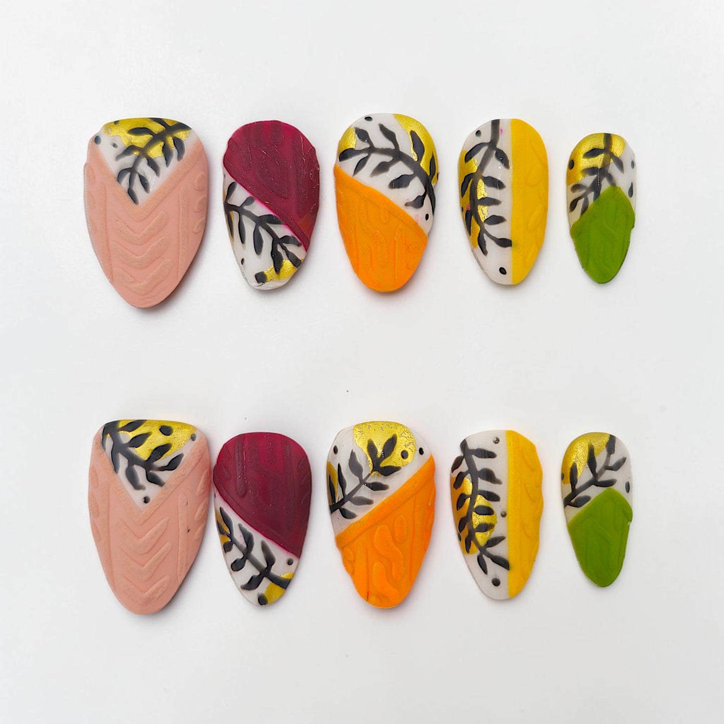 Auntie Cookies Nails: Set of 10 press-on nails with abstract leaf and swirl designs in pink, orange, yellow, green, and burgundy.