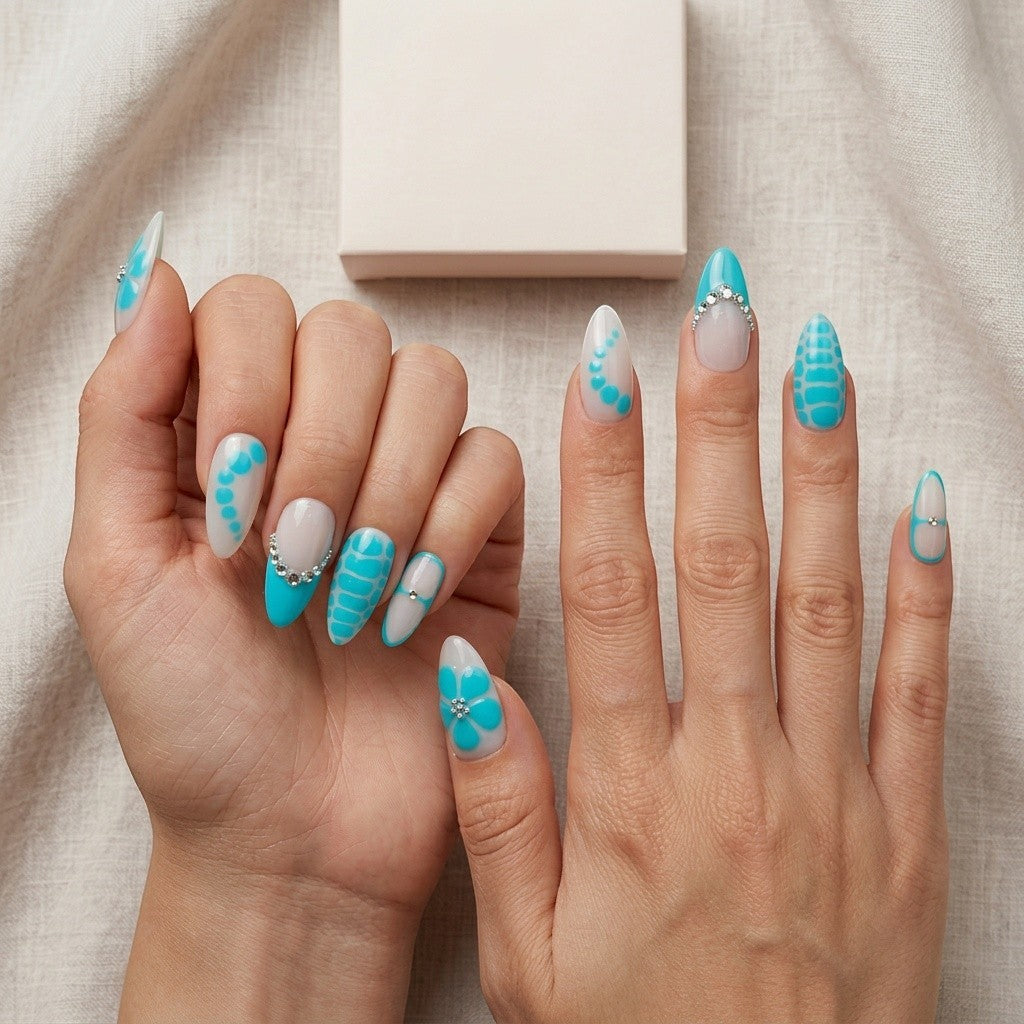 Auntie Cookies Nails Aqua Lagoon press on nails with milky white and aqua blue designs, crystal accents, and floral details.