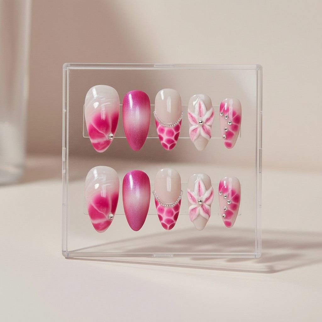 Auntie Cookies Nails Blush Bloom press on nails with pink and white gradient, floral designs, rhinestones, and glitter. Almond shape.