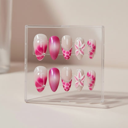 Auntie Cookies Nails Blush Bloom press on nails with pink and white gradient, floral designs, rhinestones, and glitter. Almond shape.