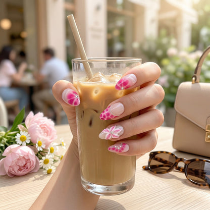 Auntie Cookies Nails Blush Bloom press on nails with pink ombre, floral, and rhinestone designs on almond-shaped tips.