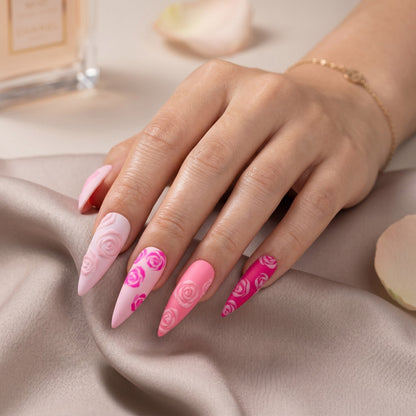 Auntie Cookies Nails almond-shaped press-on nails in a pink gradient with 3D embossed rose patterns and matte finish.