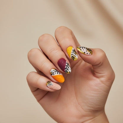 Auntie Cookies Nails: Set of 10 press-on nails with matte finish in pink, burgundy, orange, yellow, and green, featuring cable knit texture and black leaf designs.
