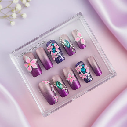 Auntie Cookies Nails Enchanted Azure Garden press on nails with purple, rose gold gradient, 3D flowers, rhinestones, and silver leaf details.