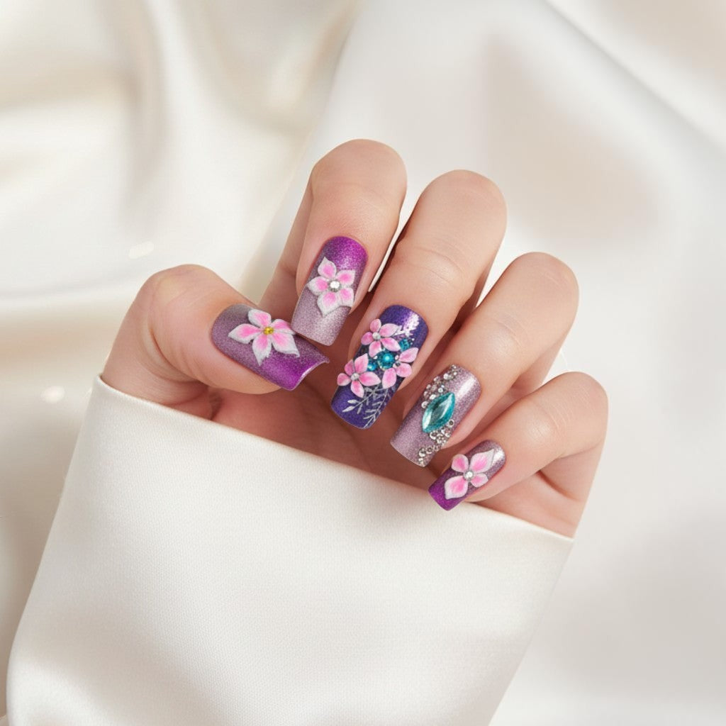 Auntie Cookies Nails Enchanted Azure Garden press-on nails with purple, rose gold gradient, 3D flowers, rhinestones, and silver leaf details.