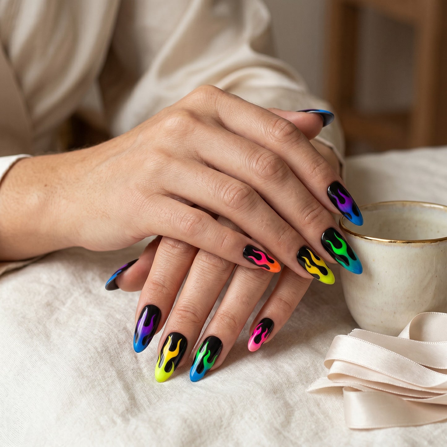 Auntie Cookies Nails almond-shaped press-on nails with a black base and vibrant neon gradient flame designs.