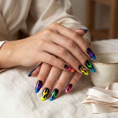 Auntie Cookies Nails almond-shaped press-on nails with a black base and vibrant neon gradient flame designs.