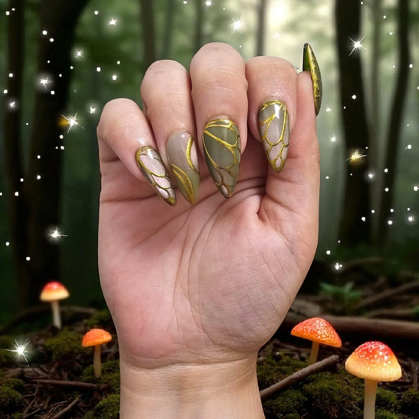 Auntie Cookies Nails Forest Fairy press on nails with green and gold wing patterns in a magical woodland setting.