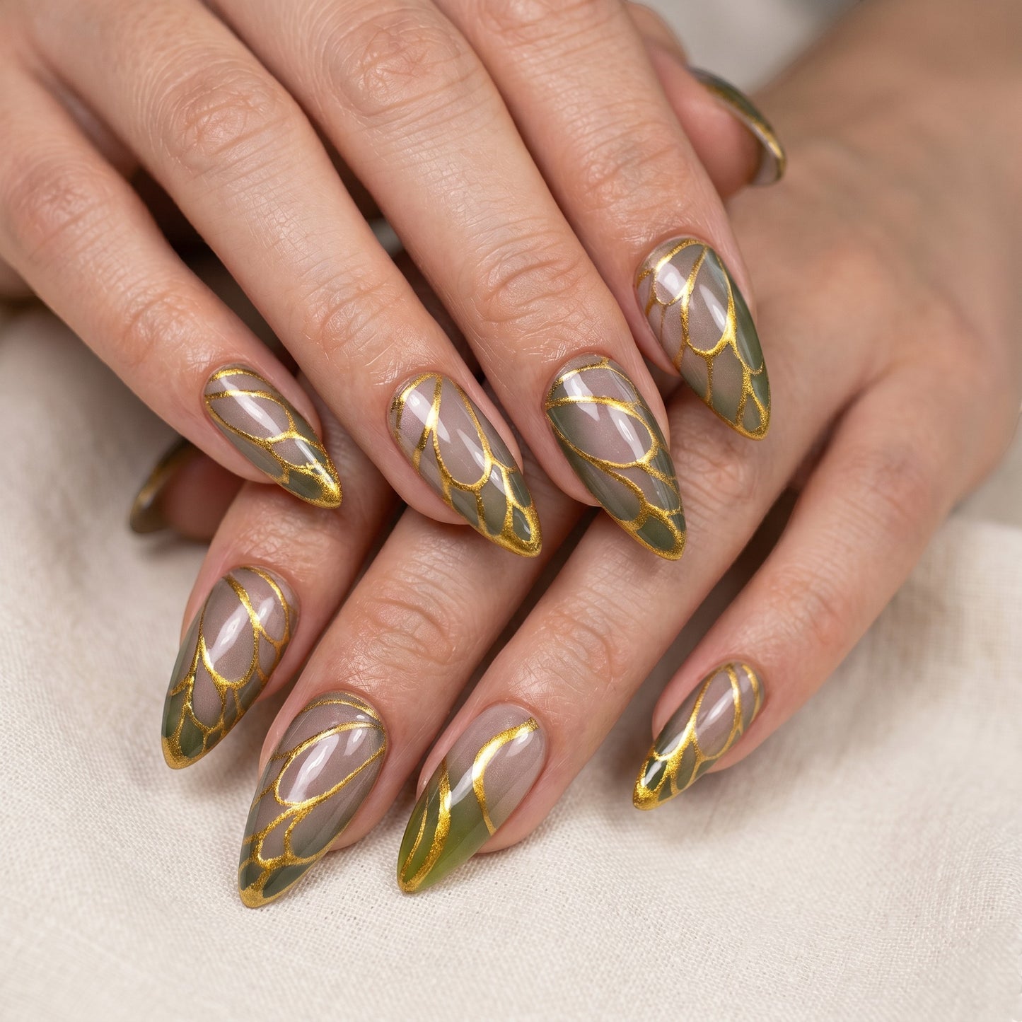 Auntie Cookies Nails Forest Fairy press on nails with almond shape, forest green tips, and gold wing-like accents.