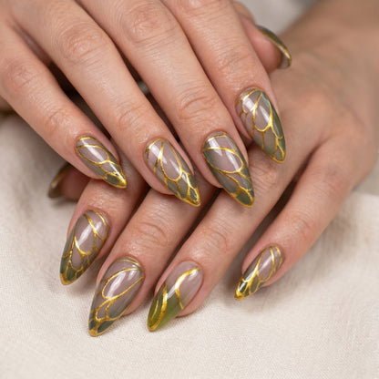 Auntie Cookies Nails Forest Fairy press on nails with almond shape, forest green tips, and gold wing-like accents.