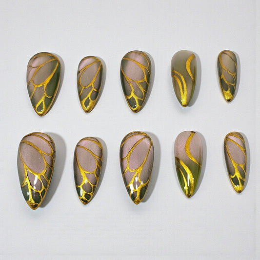 Auntie Cookies Nails Forest Fairy press on nails featuring a forest green and mauve gradient with gold wing patterns.