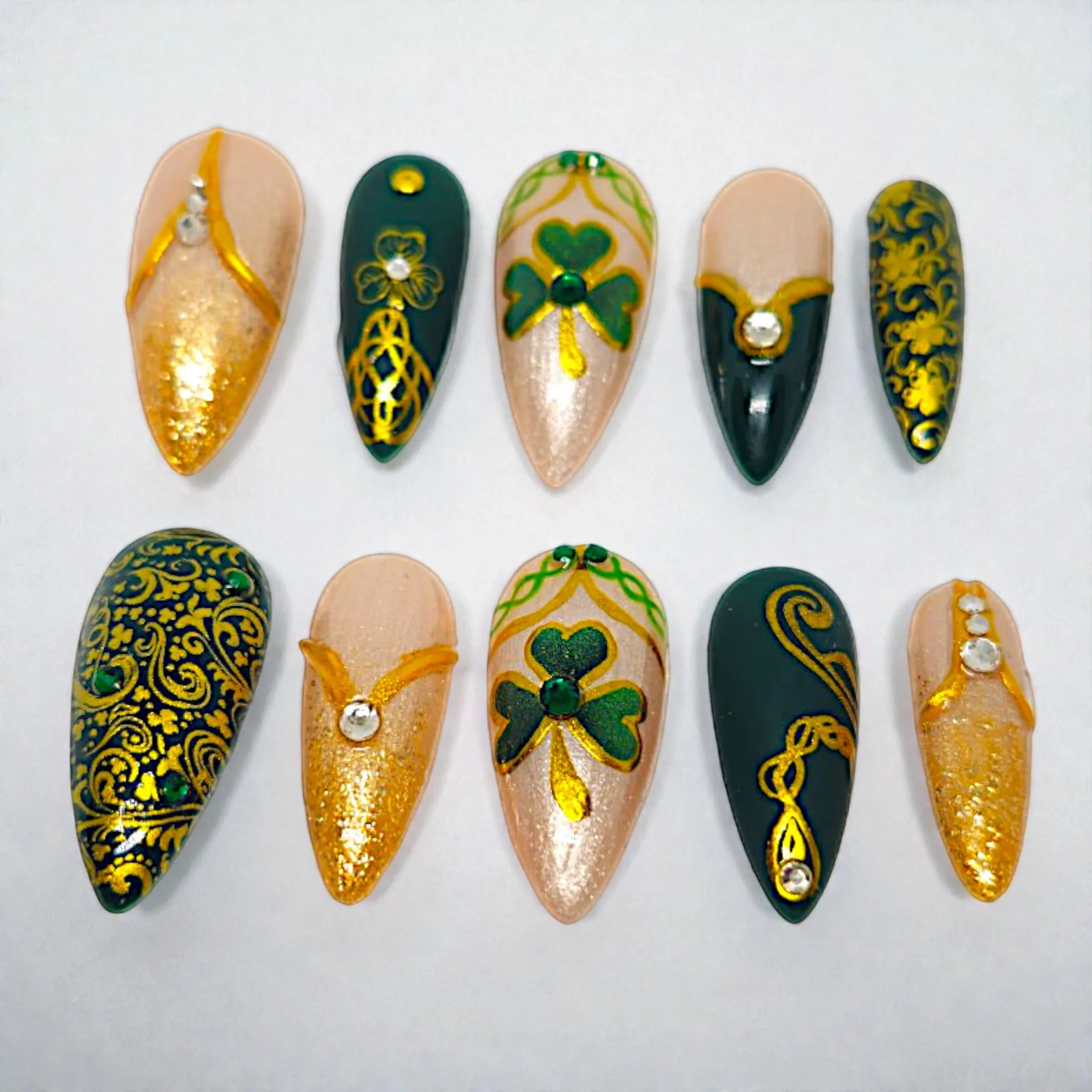 Auntie Cookies Nails Gaelic Glam press on nails with emerald green, gold, and champagne shimmer. Celtic knot and clover designs with rhinestones.
