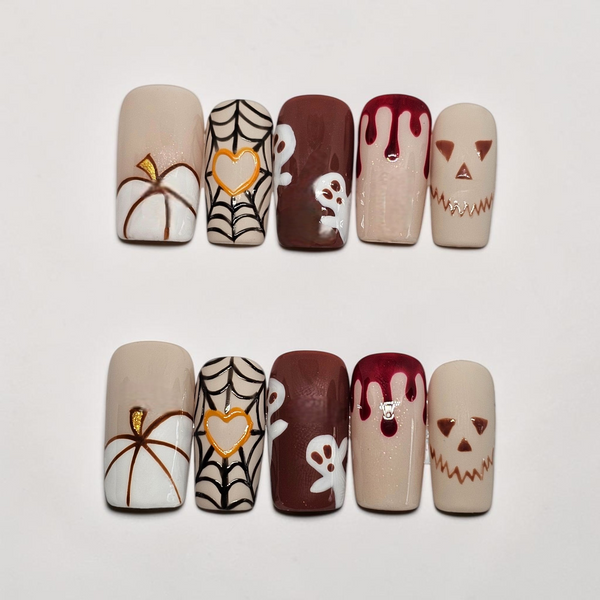 Auntie Cookies Nails Pumpkin Spice & Everything Fright press-on nails featuring ghosts, spider webs, and pumpkins.