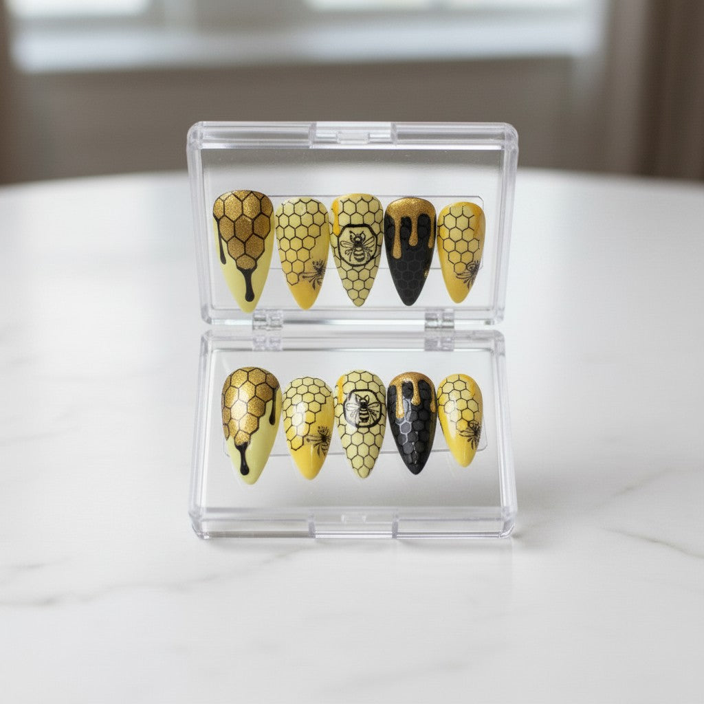 Auntie Cookies Nails Honey Bee press on nails with honeycomb and bee designs in yellow and black.