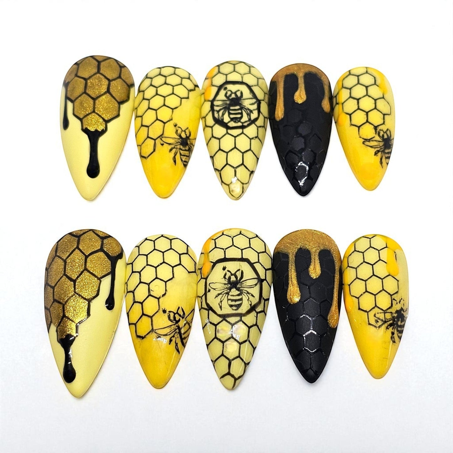 Auntie Cookies Nails: Yellow and black almond press-on nails with honeycomb, bee, and dripping honey designs.