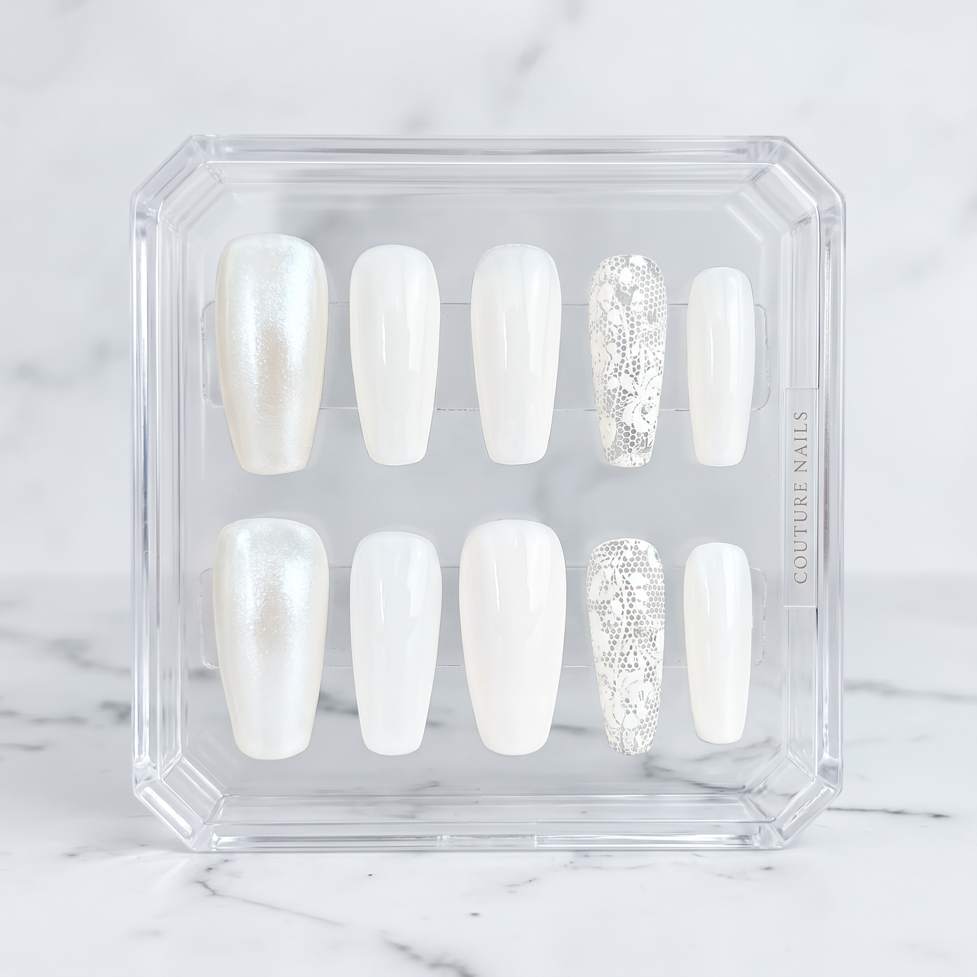 Auntie Cookies Nails ivory coffin press-on nails featuring pearlescent, glossy, and intricate lace accent designs.