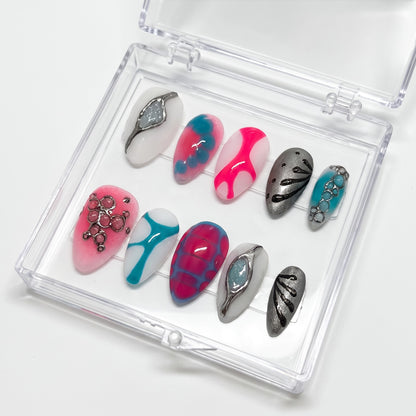 Auntie Cookies Nails Neon Aura press-on set with neon pink, electric blue, and metallic silver 3D abstract designs.