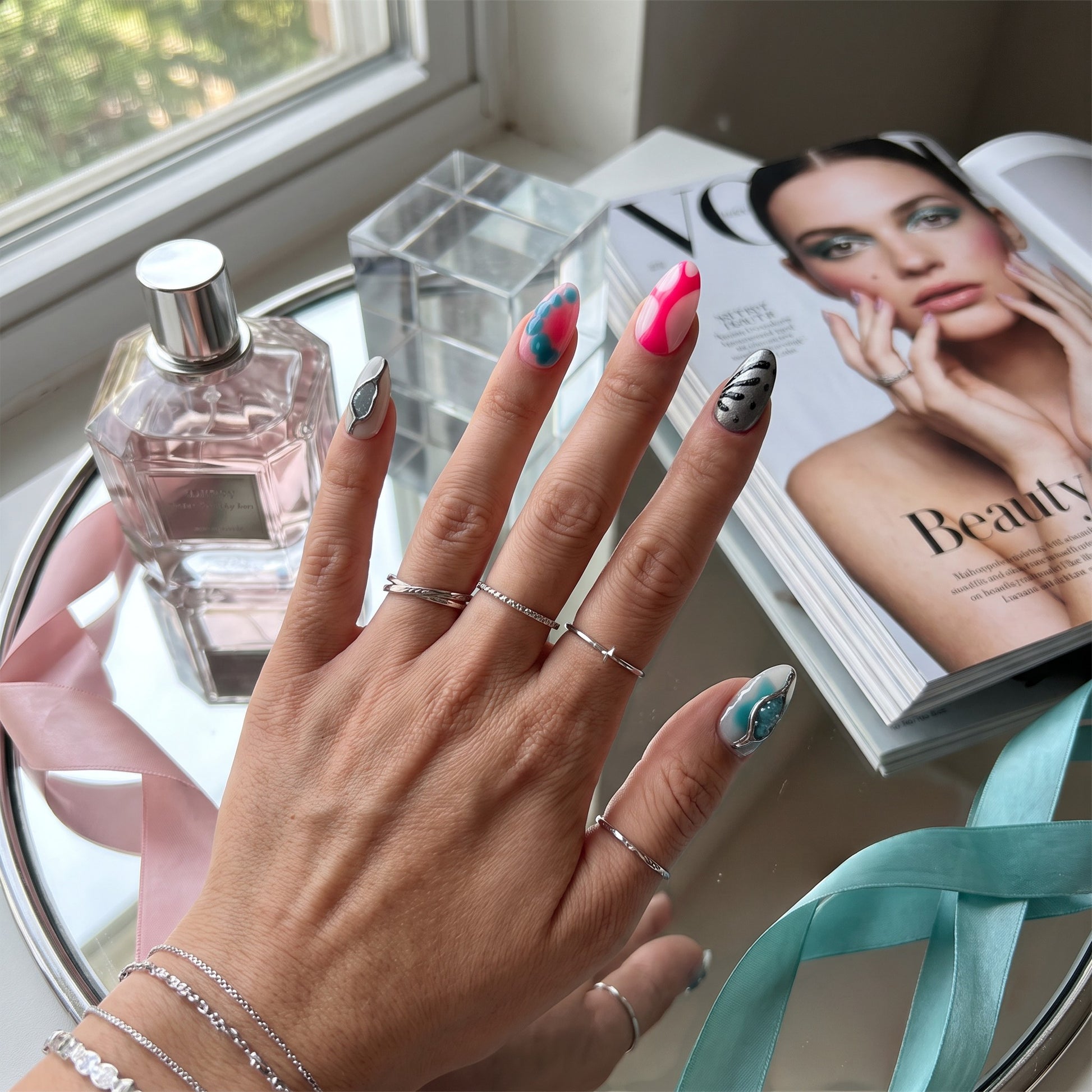 Auntie Cookies Nails Neon Aura press-on nails featuring neon pink, blue, and metallic silver 3D abstract designs.