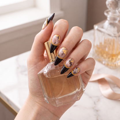 Auntie Cookies Nails Obsidian Reign almond-stiletto press-on nails with black, marble, and gold chain accents.