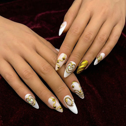 Auntie Cookies Nails Opulent Ivory press on nails with gold heart designs, pearls, and textured accents. Stiletto shape.