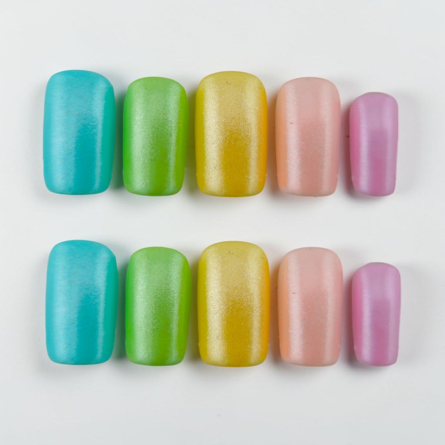 Auntie Cookies Nails pastel press on nails in teal, lime green, yellow, pink, and lavender with a matte finish.