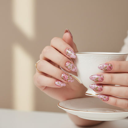 Auntie Cookies Nails Petal Prism Press On Nails feature a delicate pink rose floral design on an iridescent pink base. Almond shape.