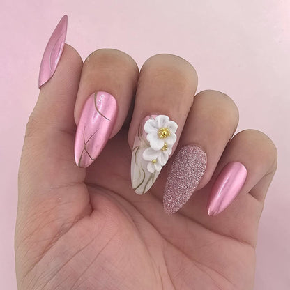 Auntie Cookies Nails: Pink metallic almond press-on nails with gold lines and 3D floral accent nail.