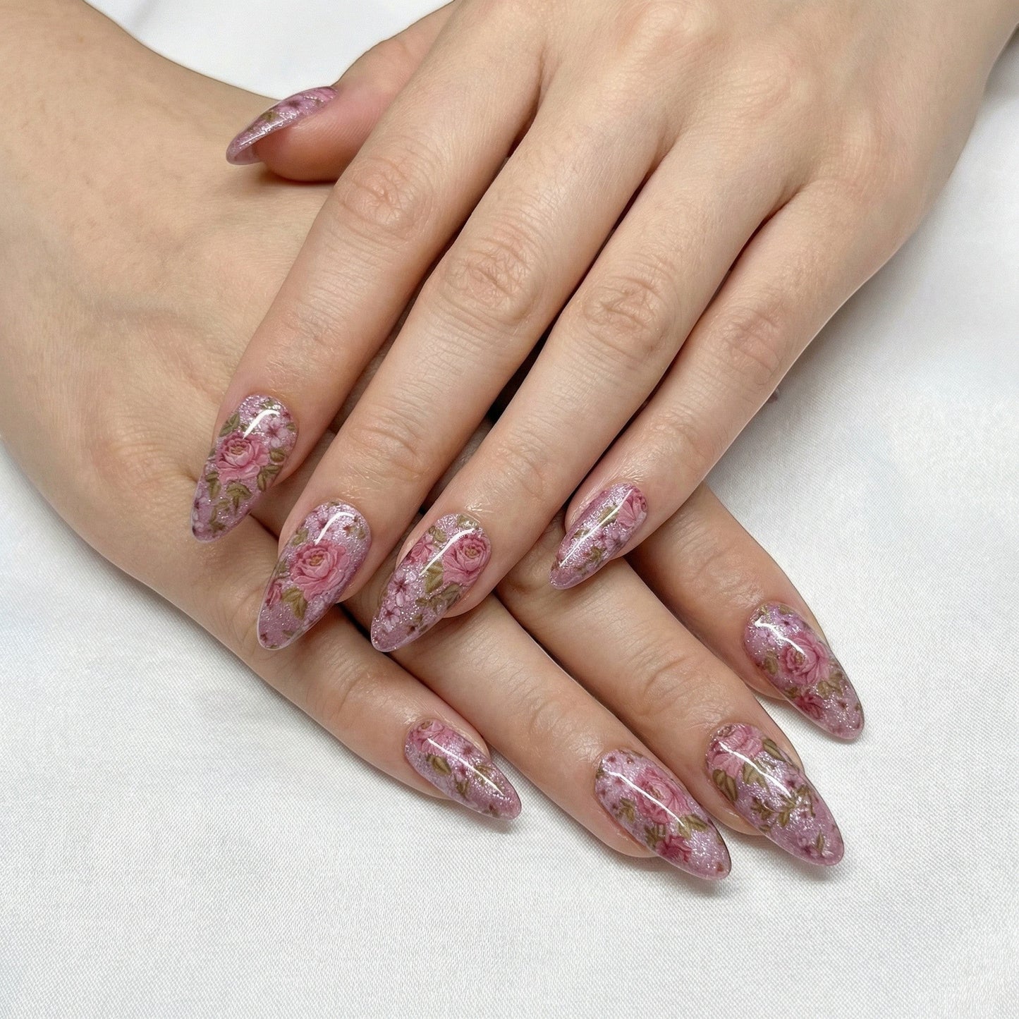 Auntie Cookies Nails pink floral cat-eye press-on nails with glitter accents.