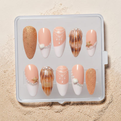Auntie Cookies Nails: Set of 10 press-on nails with peach, white, and sandy brown colors, featuring pearl, seashell, and starfish accents.