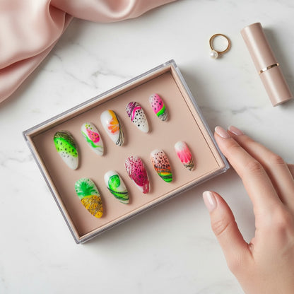 Auntie Cookies Nails: Tropical abstract fruit press-on nails with watermelon, pineapple, lime, and citrus designs.