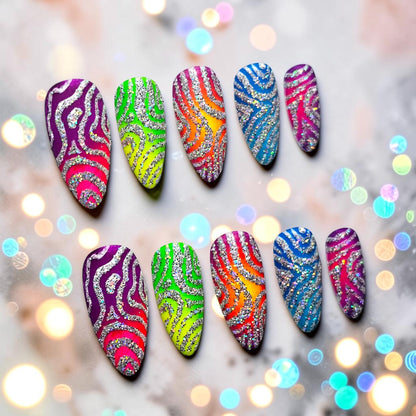 Auntie Cookies Nails Zebra Pop Parade press-on nails with neon rainbow colors, silver glitter, and zebra print design.
