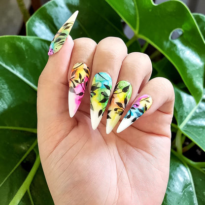 Auntie Cookies Nails: Almond-shaped press-on nails with vibrant watercolor design and black foliage. Glossy finish.