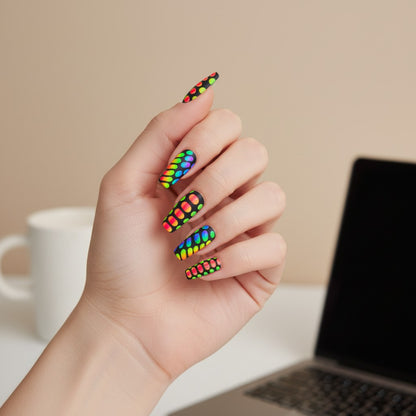 Auntie Cookies Nails neon rainbow snake print stiletto press-on nails with matte black background.